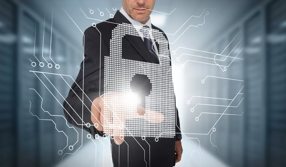 Businessman selecting a futuristic padlock with a data center on the background